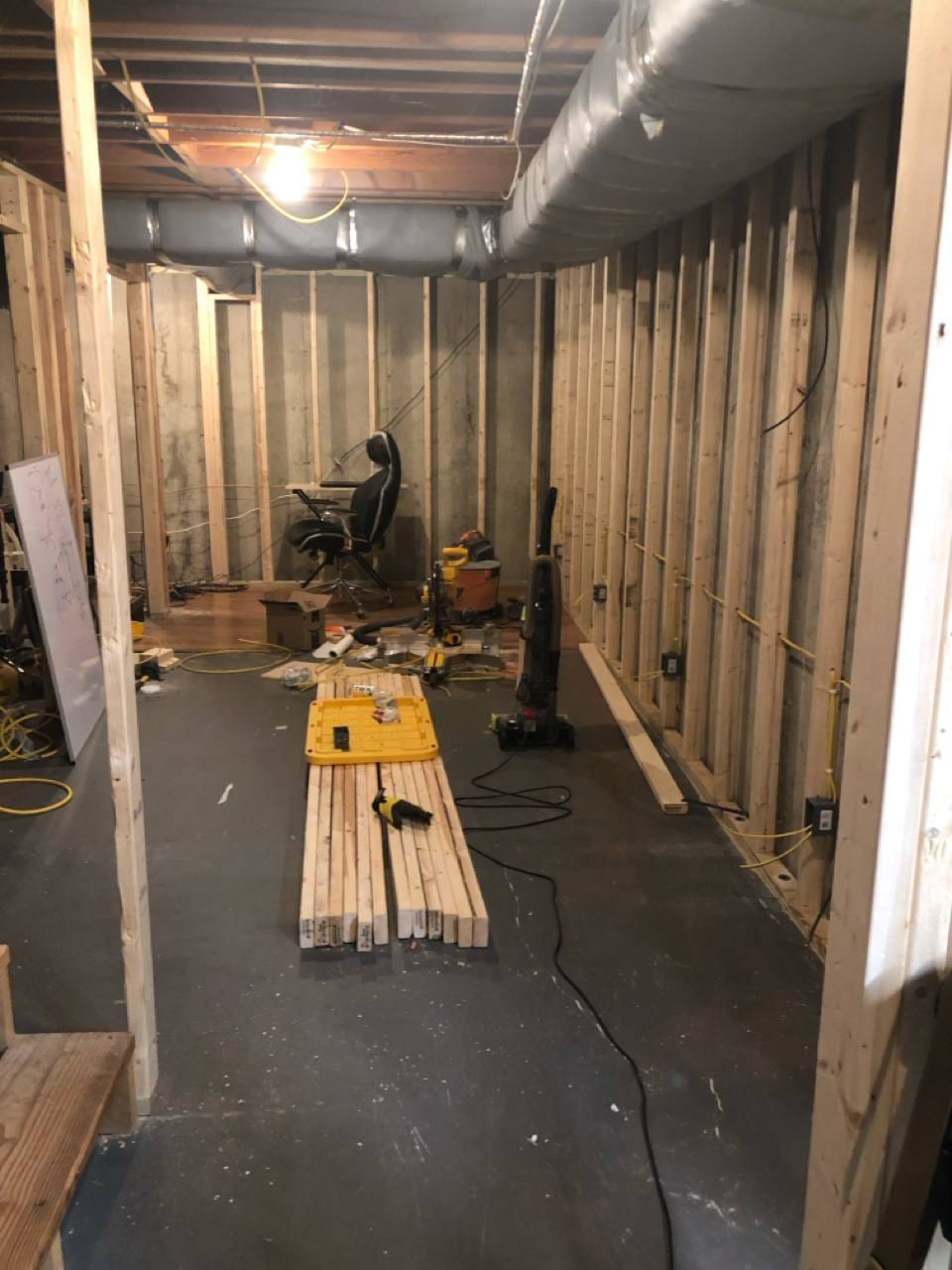 Unfinished basement during framing with new stud walls and routed electrical