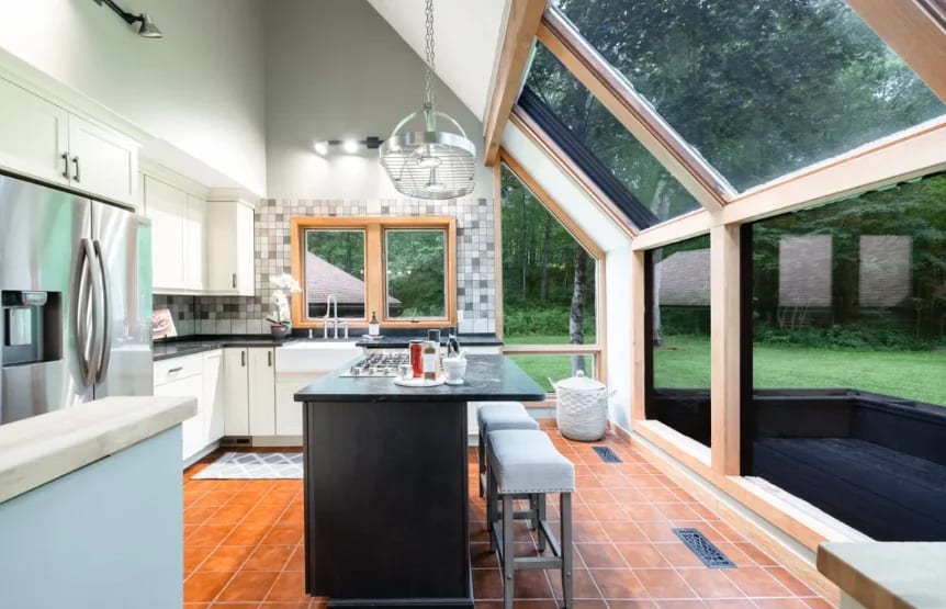 Finished sunroom kitchen with a vaulted glass ceiling, remodeled by Zipoli Home Services
